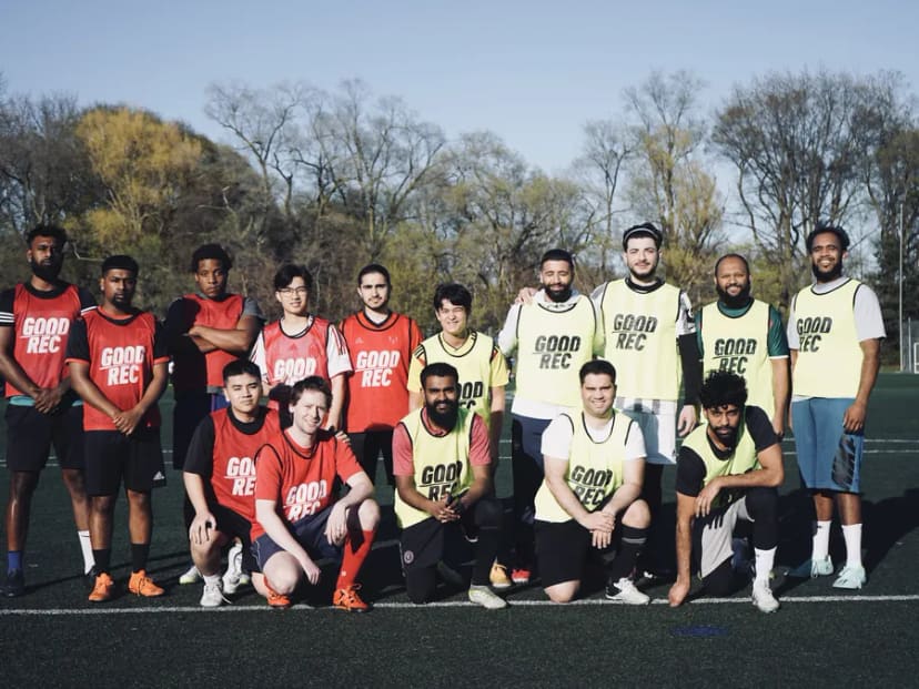 A full squad of players in GoodRec bibs posing after a game