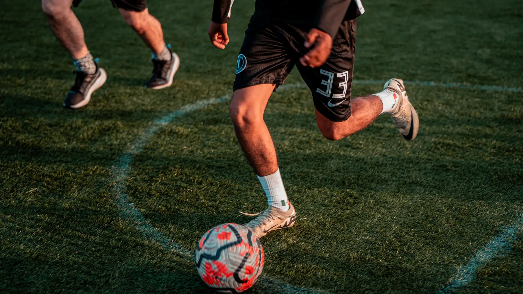 A player striking the ball during a GoodRec pickup soccer game